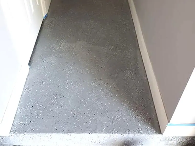 Speckled grey floor coating beside a doorway